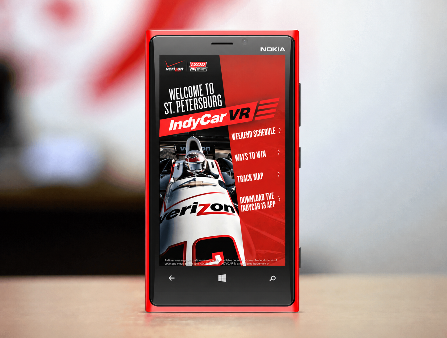 A single red Nokia phone showing the IndyCar homepage with the IndyCar VR banner above the four navigation links